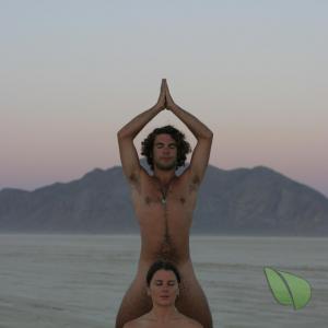 A nude friends doing yoga poses in the wilderness