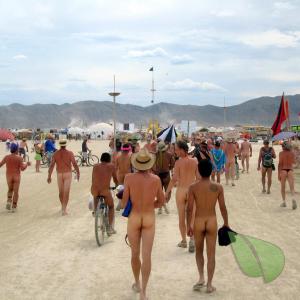 a group of naturists with cool tattoos near the woods