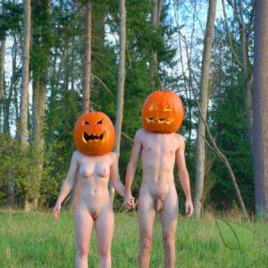 A nudist couple ready for halloween outdoors