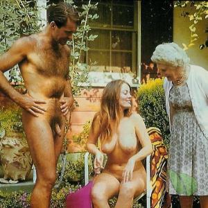 Solo nudist couple posing in their house outside