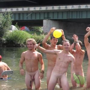 a crowd of men enjoying the water outside
