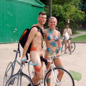A nudist couple being bodypainted out and about