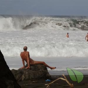 One nude couple relaxing in the water outside