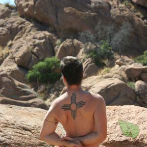 Solo dude with cool tattoos in the wilderness
