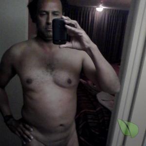 Solo nudist sitting at home