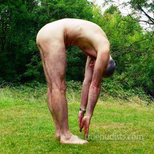 A male trying yoga outdoors