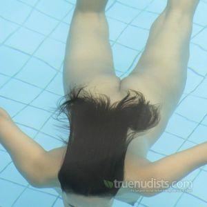 Solo nudists relaxing in the pool