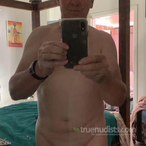A nudist relaxing at home