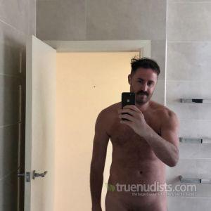 Solo nudist relaxing at home