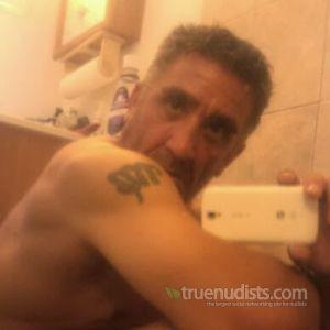 Solo nudist relaxing at home