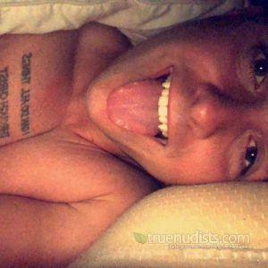 Solo nudist sitting at home