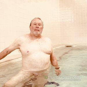 One nudist relaxing in the pool