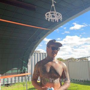 A guy with cool tattoos outside