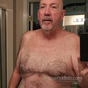 A nudist posing in their house